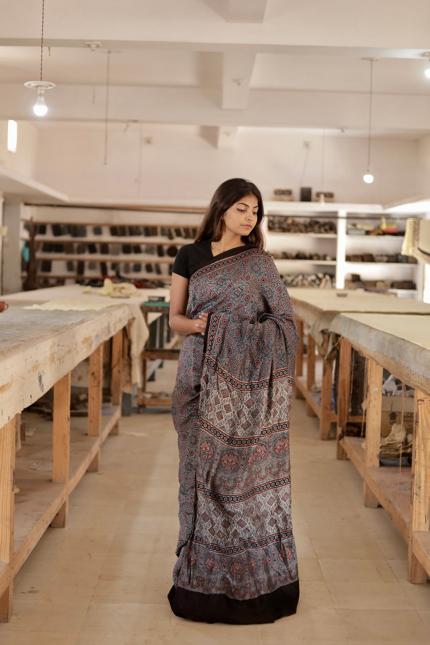 Dusty blue Ajrakh modal silk saree featuring intricate hand block printed motifs and a graceful drape