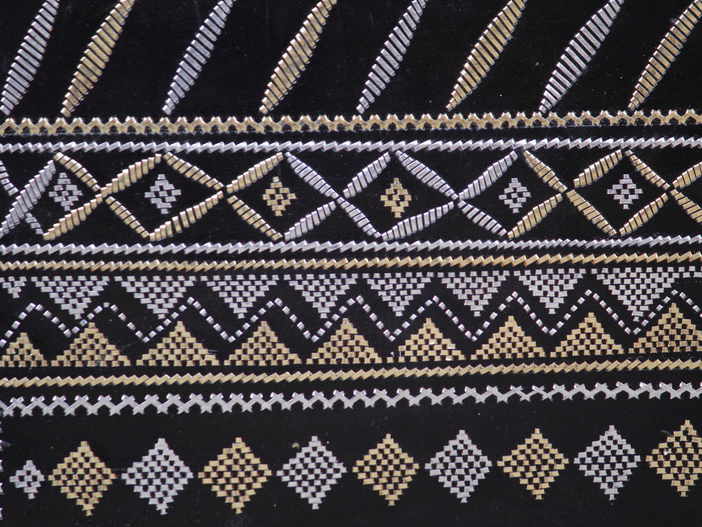 Artisan-made black leather bag featuring traditional metallic zari embellishments