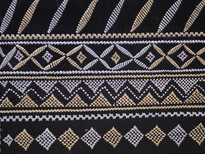 Artisan-made black leather bag featuring traditional metallic zari embellishments
