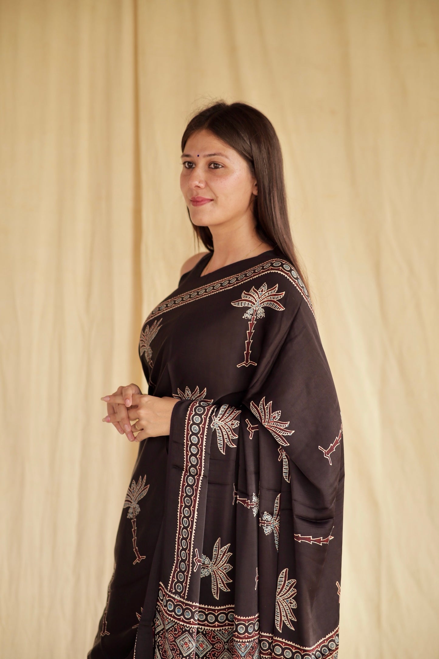 Elegant Black Lotus Ajrakh saree in modal silk showcasing skilled artisan block printing techniques