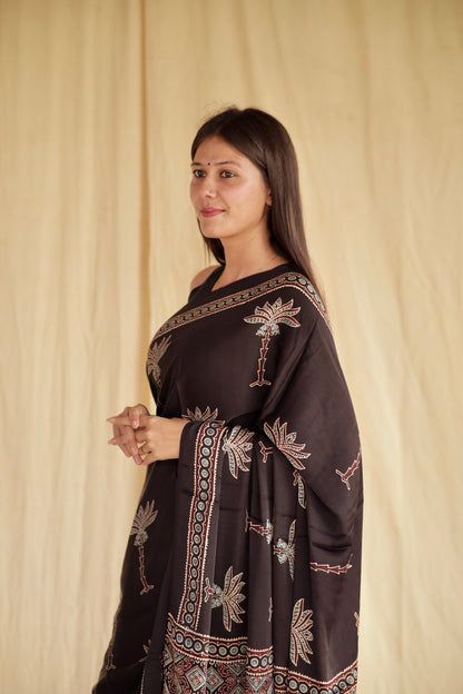 Elegant Black Lotus Ajrakh saree in modal silk showcasing skilled artisan block printing techniques
