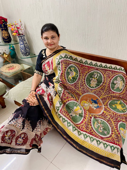 Elegant black saree showcasing detailed Mata Ni Pachedi artwork created by skilled artisans