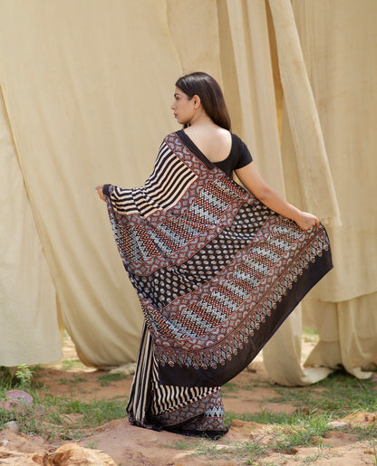 Elegant black and white stripe Ajrakh saree in modal silk showcasing skilled artisan block printing techniques