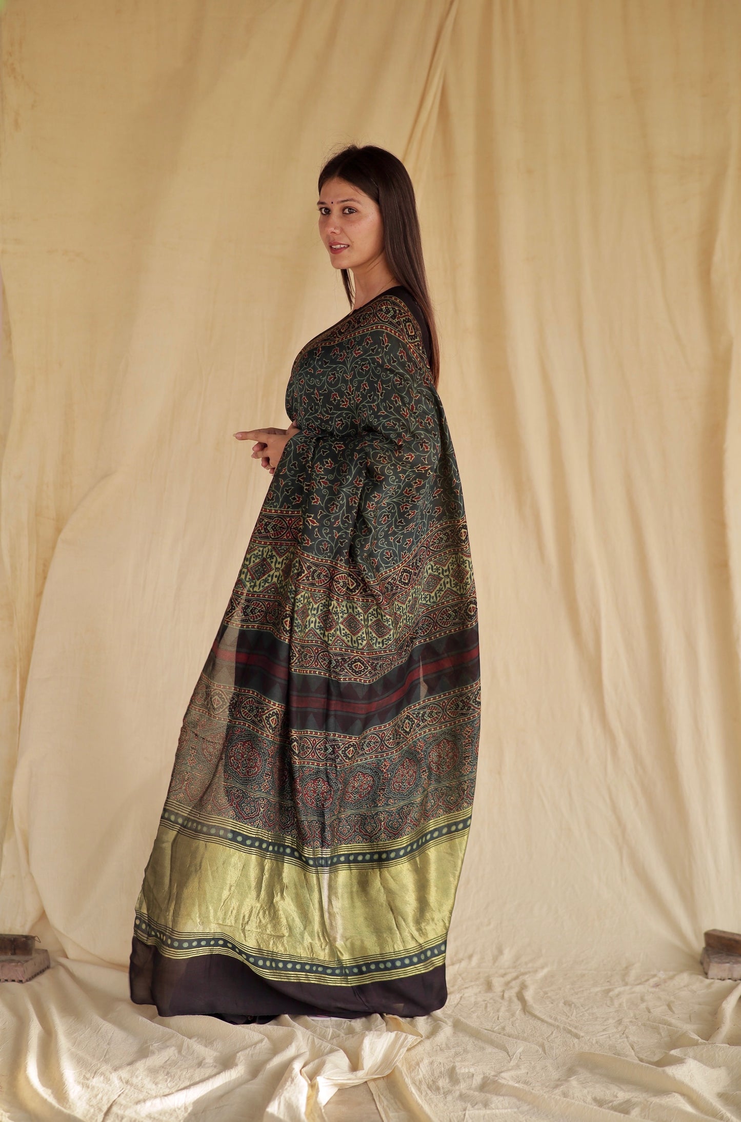 Elegant bottle green Ajrakh saree in modal silk showcasing detailed artisan block printing