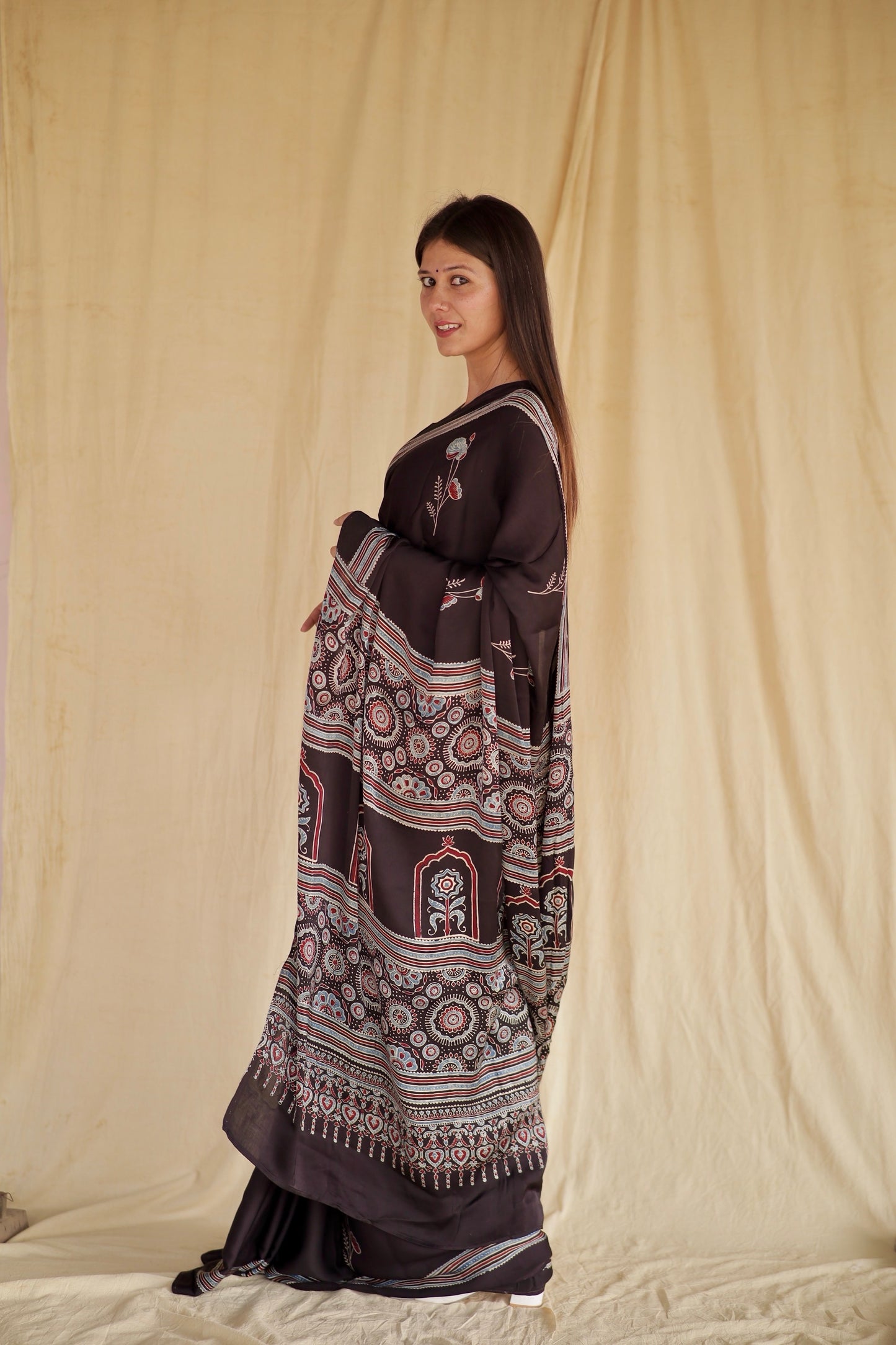 Elegant charcoal black Ajrakh saree in modal silk showcasing detailed artisan block printing techniques