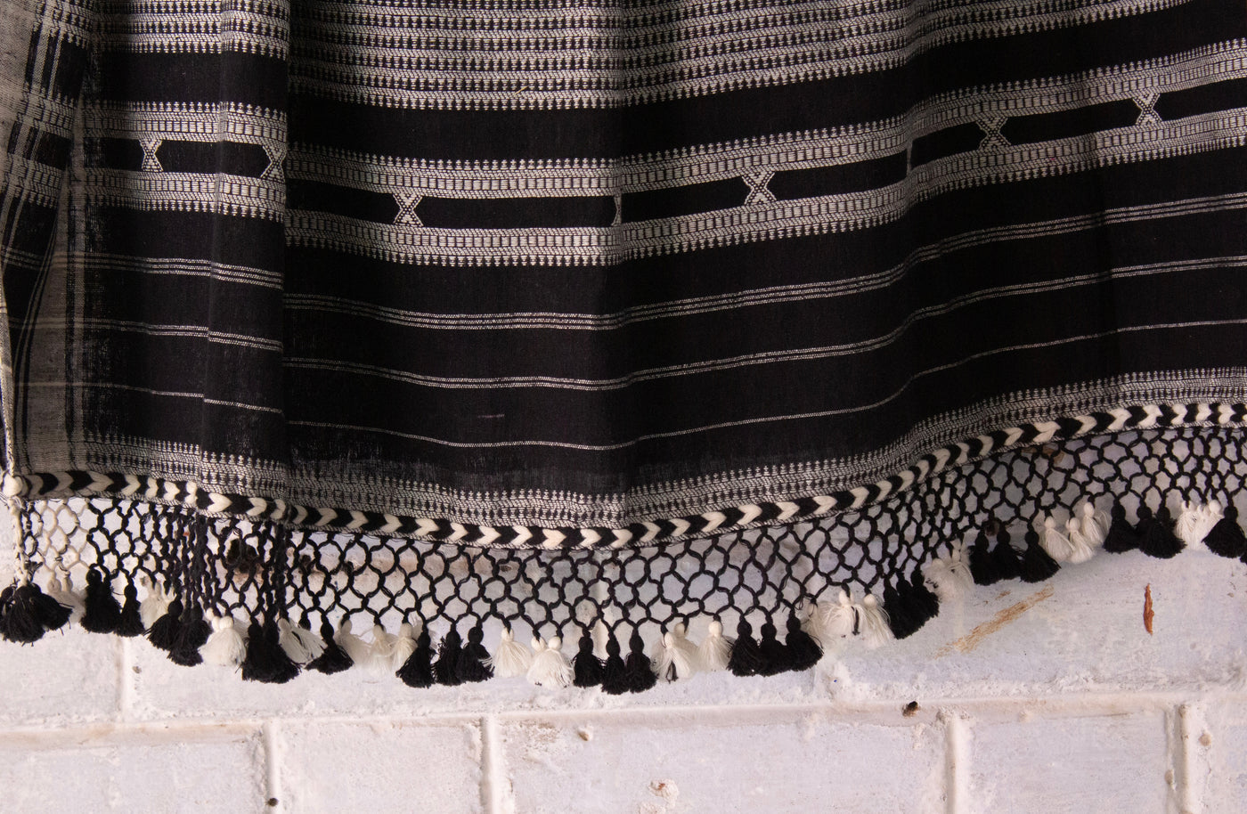 Elegant charcoal Bhujodi saree woven in sustainable Kala Cotton with intricate artisan detailing