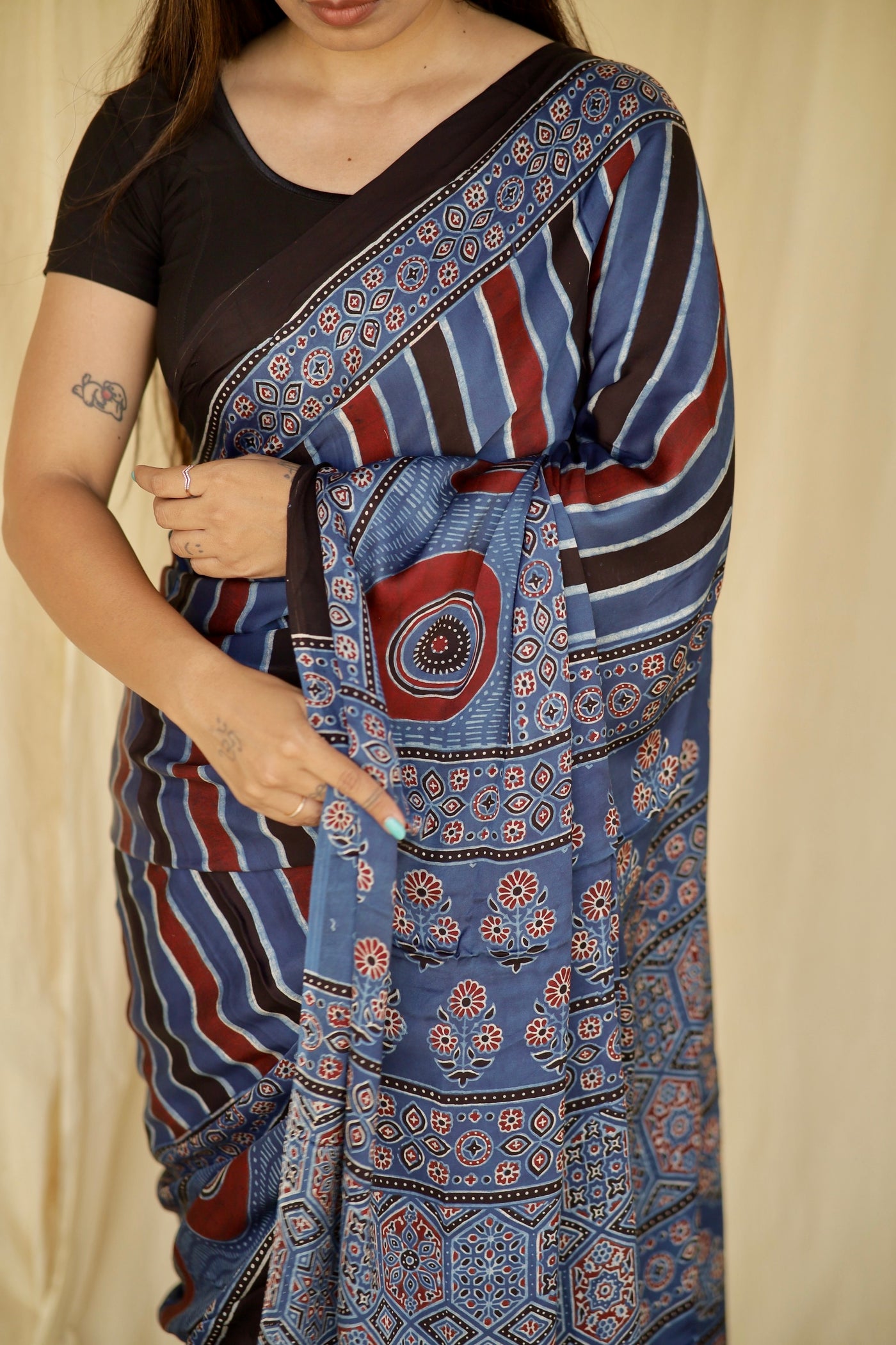 Elegant cobalt blue Ajrakh saree in modal silk showcasing skilled artisan block printing techniques