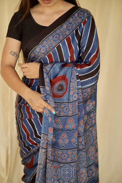 Elegant cobalt blue Ajrakh saree in modal silk showcasing skilled artisan block printing techniques