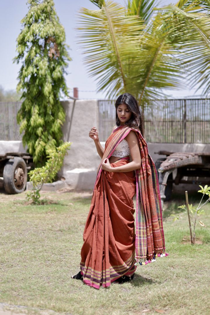 Elegant copper Bhujodi saree woven in sustainable Kala Cotton with intricate artisan detailing