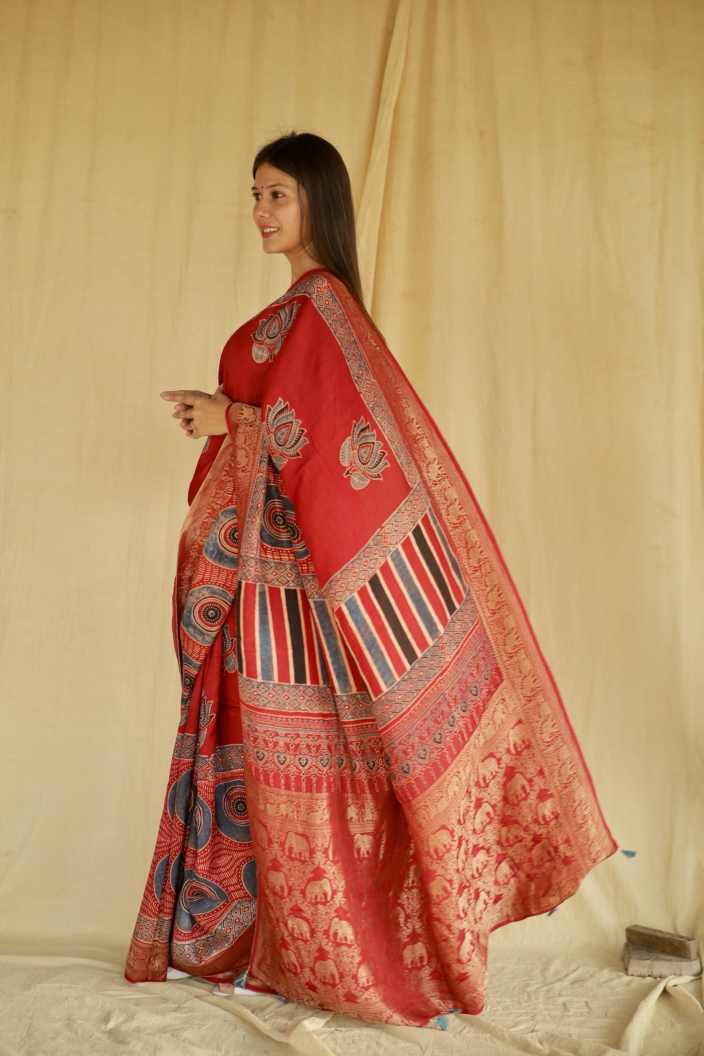 Elegant crimson red Ajrakh saree crafted in Dola silk with detailed artisan block printing
