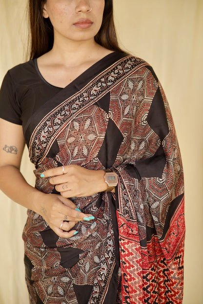 Elegant dark mocha Ajrakh saree in modal silk showcasing skilled artisan block printing techniques
