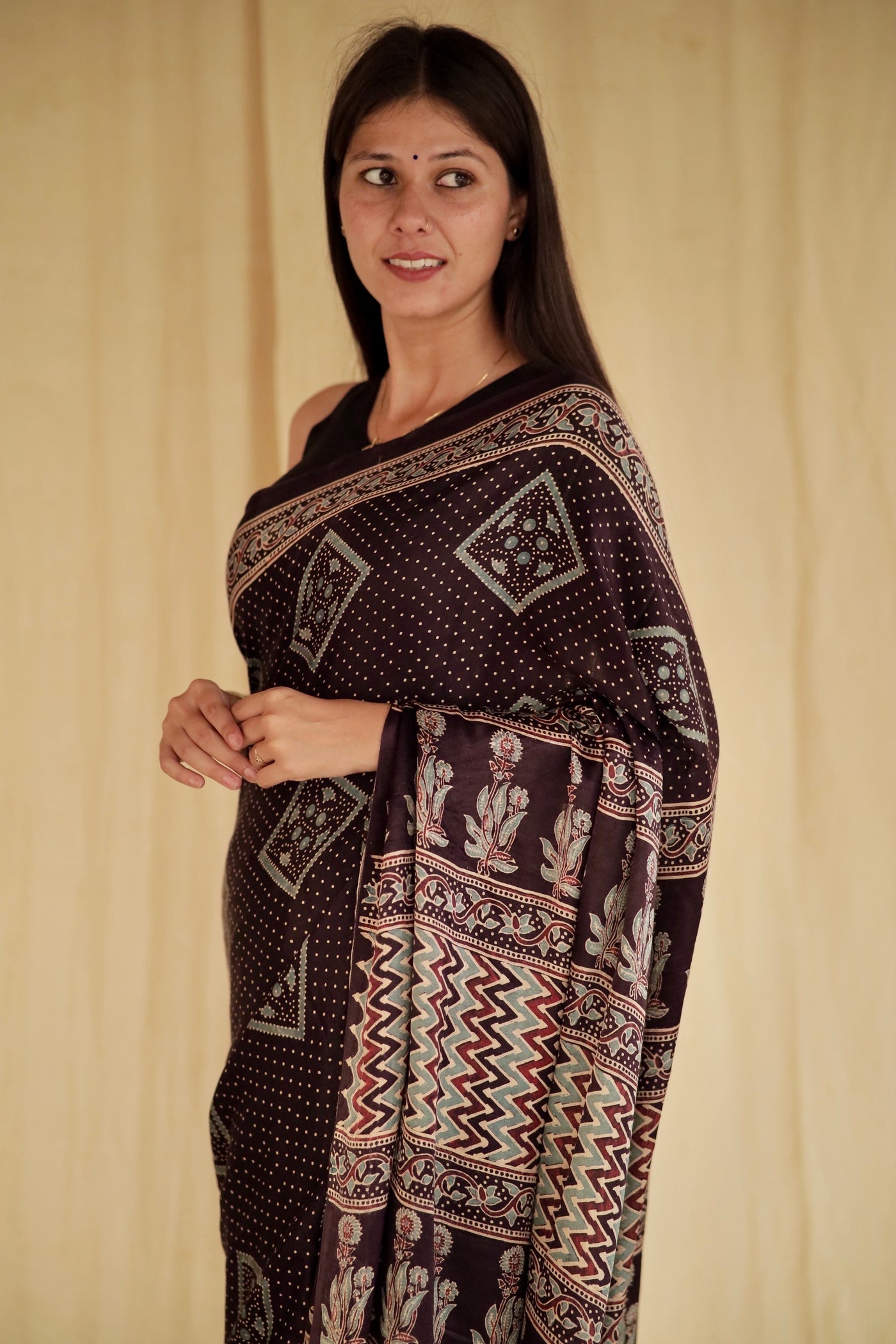 Elegant deep black Ajrakh saree crafted in luxurious modal silk with timeless geometric designs