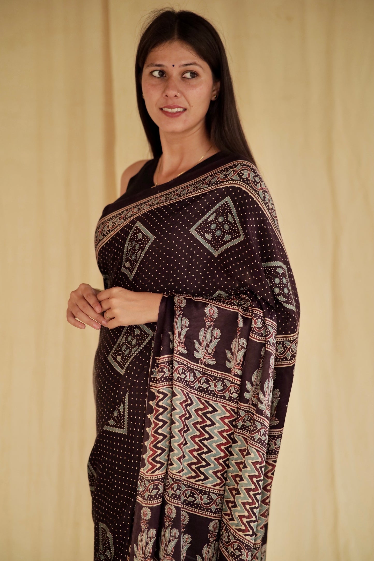 Elegant deep black Ajrakh saree crafted in luxurious modal silk with timeless geometric designs