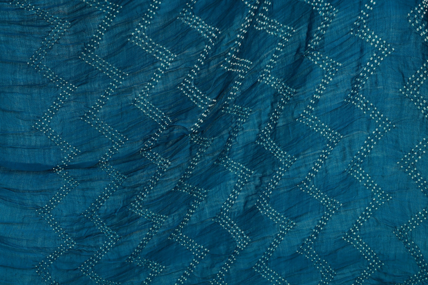 Deep sea Rai Bandhani silk saree featuring intricate tie-dye patterns and an elegant zari pallu