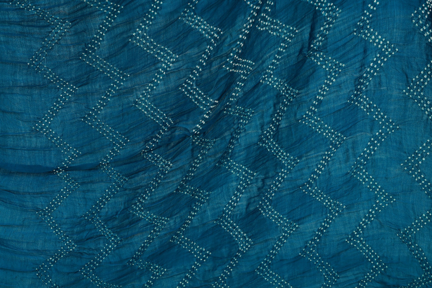 Deep sea Rai Bandhani silk saree featuring intricate tie-dye patterns and an elegant zari pallu
