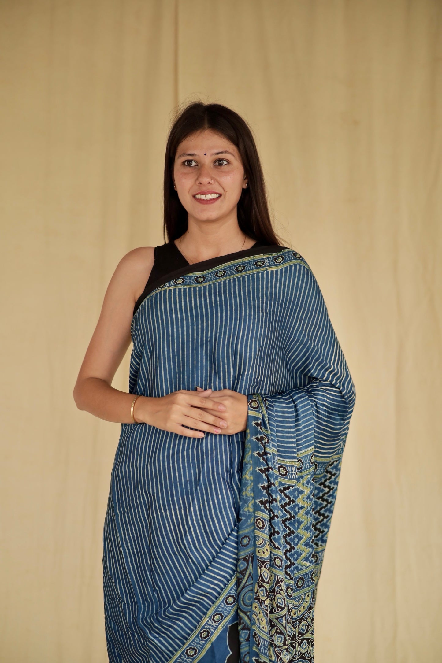 Elegant denim blue Ajrakh saree in modal silk showcasing skilled artisan block printing techniques