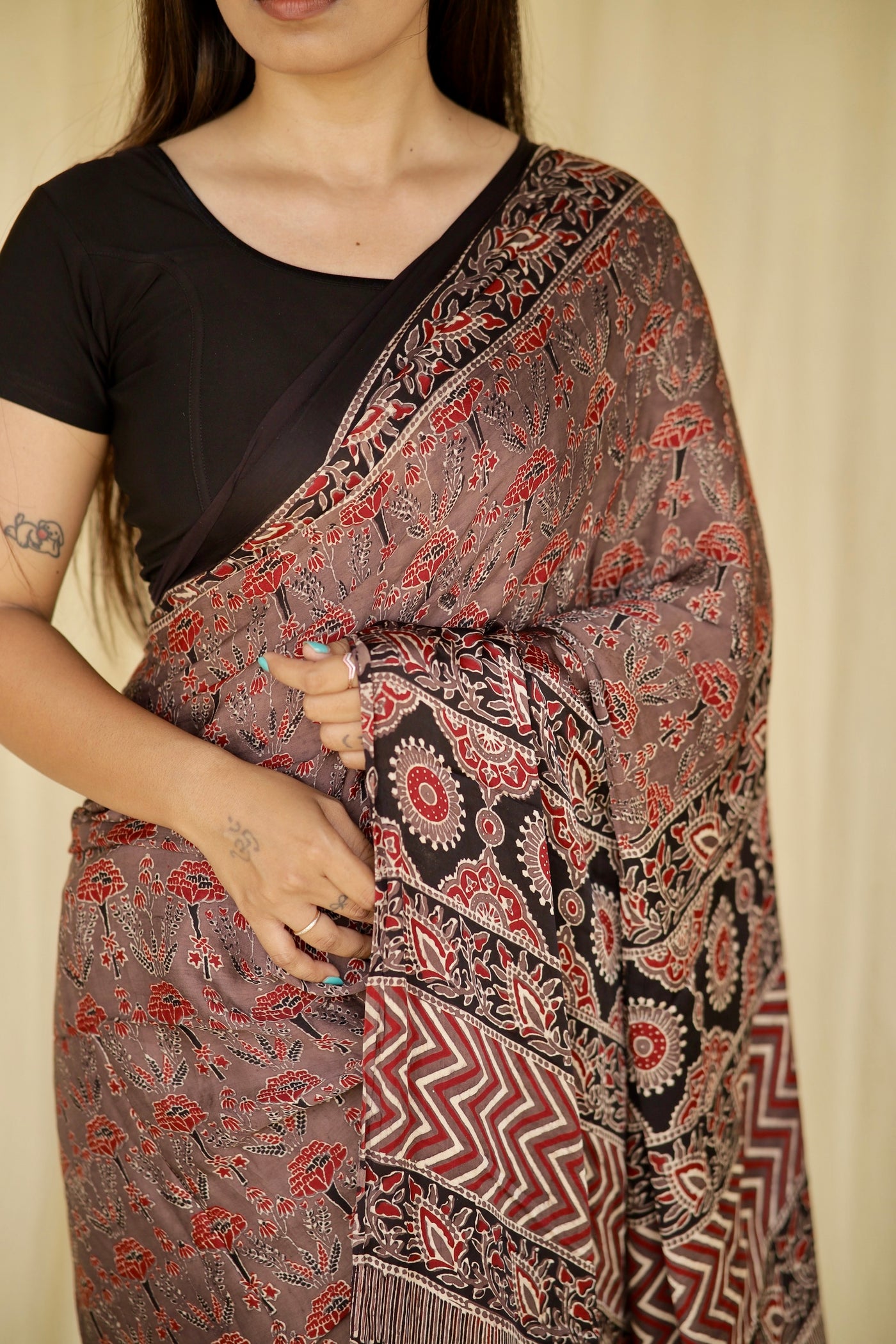 Elegant dusty rose Ajrakh saree in modal silk showcasing detailed artisan block printing techniques