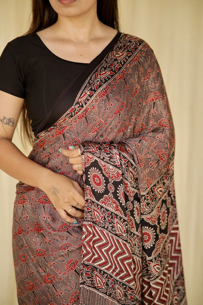 Elegant dusty rose Ajrakh saree in modal silk showcasing detailed artisan block printing techniques