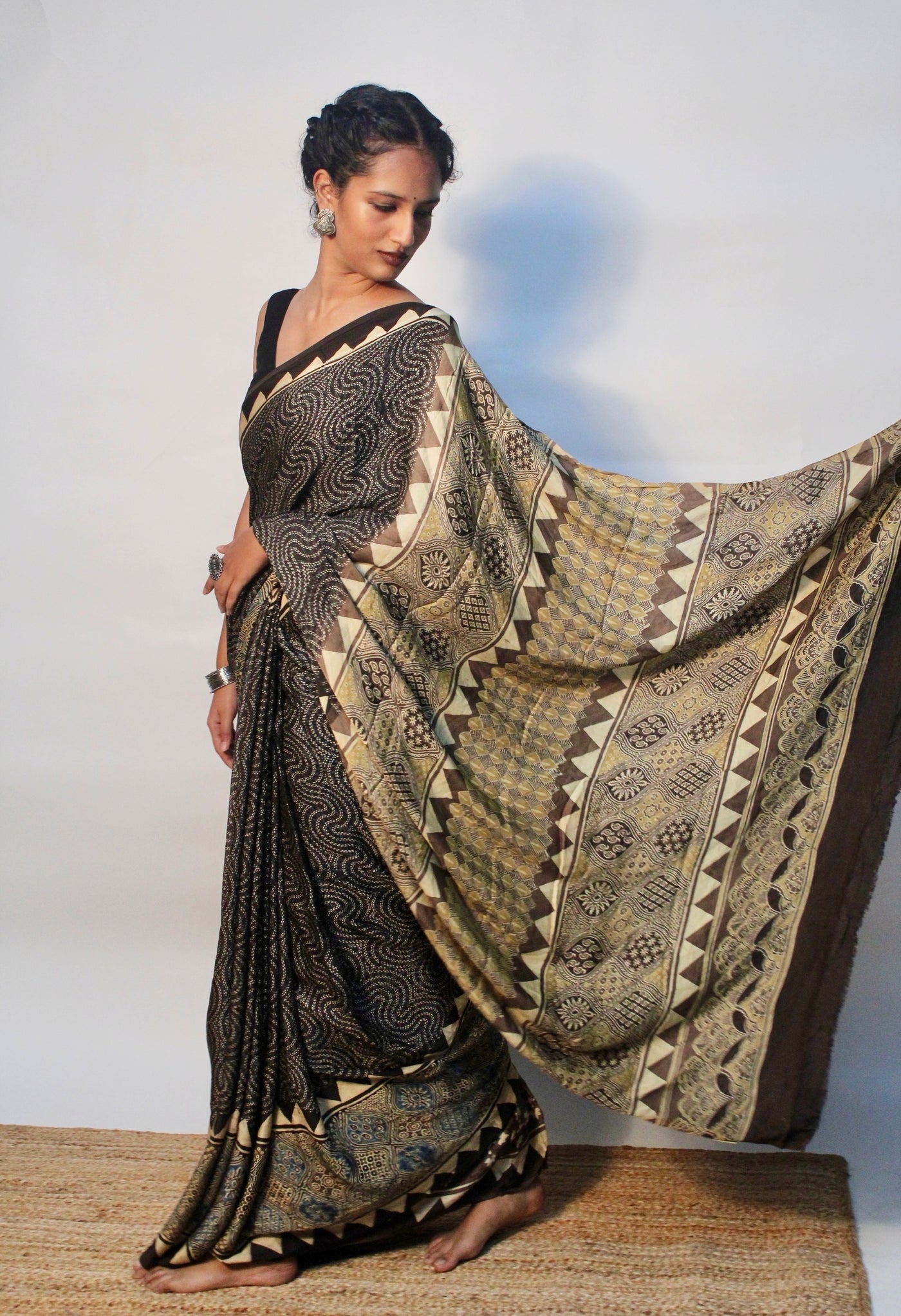 Elegant espresso brown Ajrakh saree in modal silk showcasing skilled artisan block printing techniques
