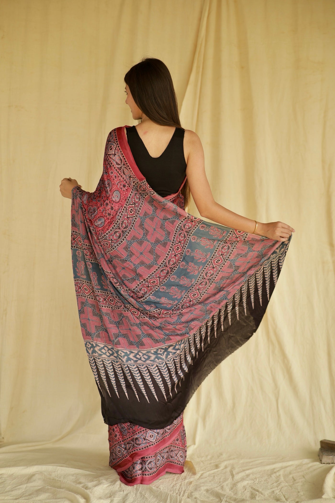 Elegant fuchsia pink Ajrakh saree in modal silk showcasing skilled artisan block printing techniques