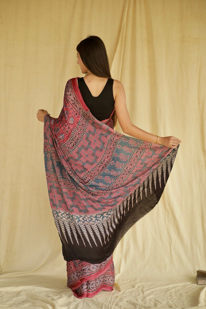 Elegant fuchsia pink Ajrakh saree in modal silk showcasing skilled artisan block printing techniques