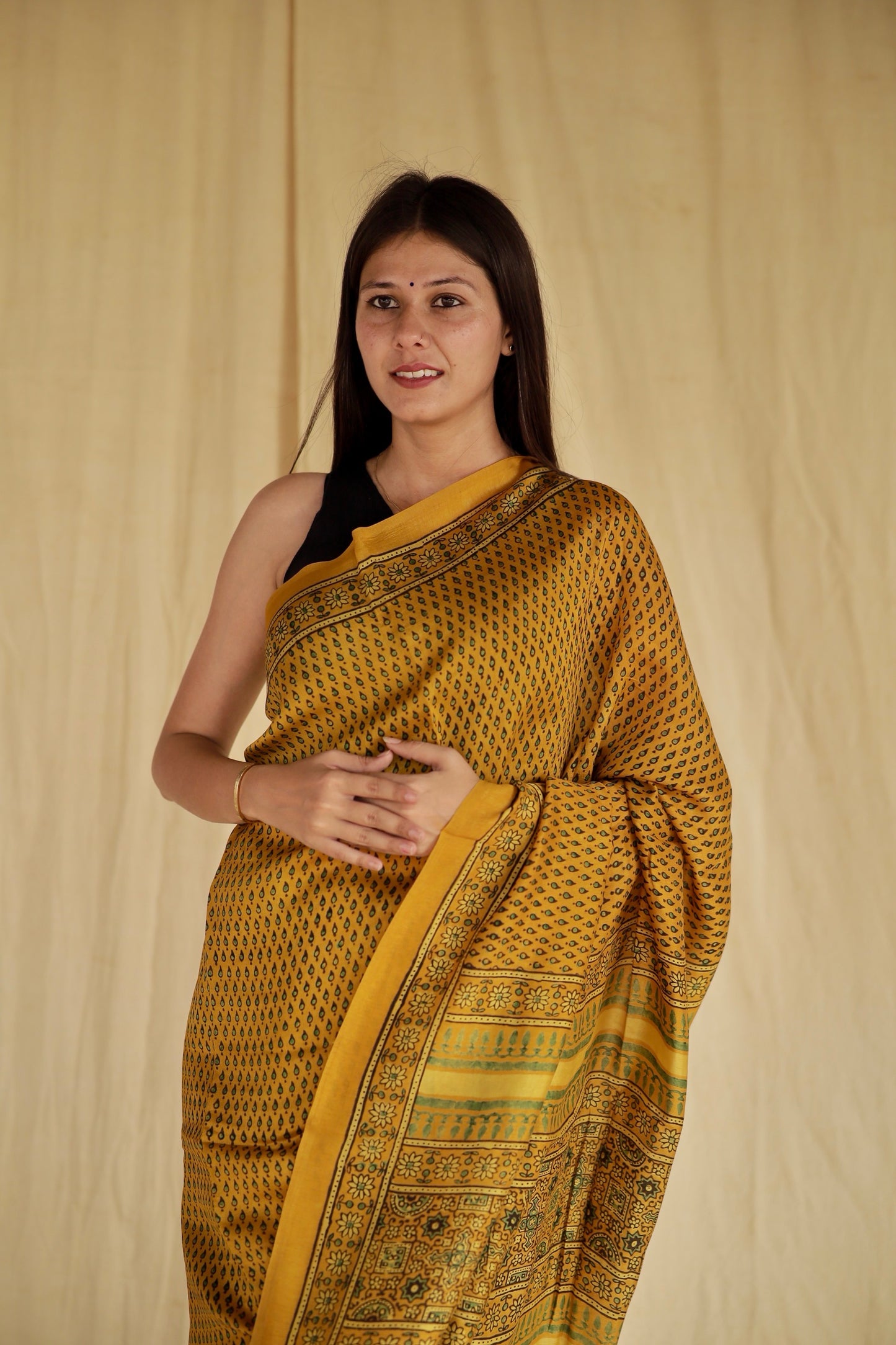 Elegant golden mustard Ajrakh saree in Chanderi silk showcasing skilled artisan block printing techniques
