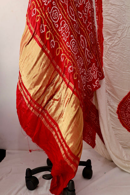 Handcrafted ivory red Gajji silk saree showcasing authentic Bandhani artistry with rich zari detailing