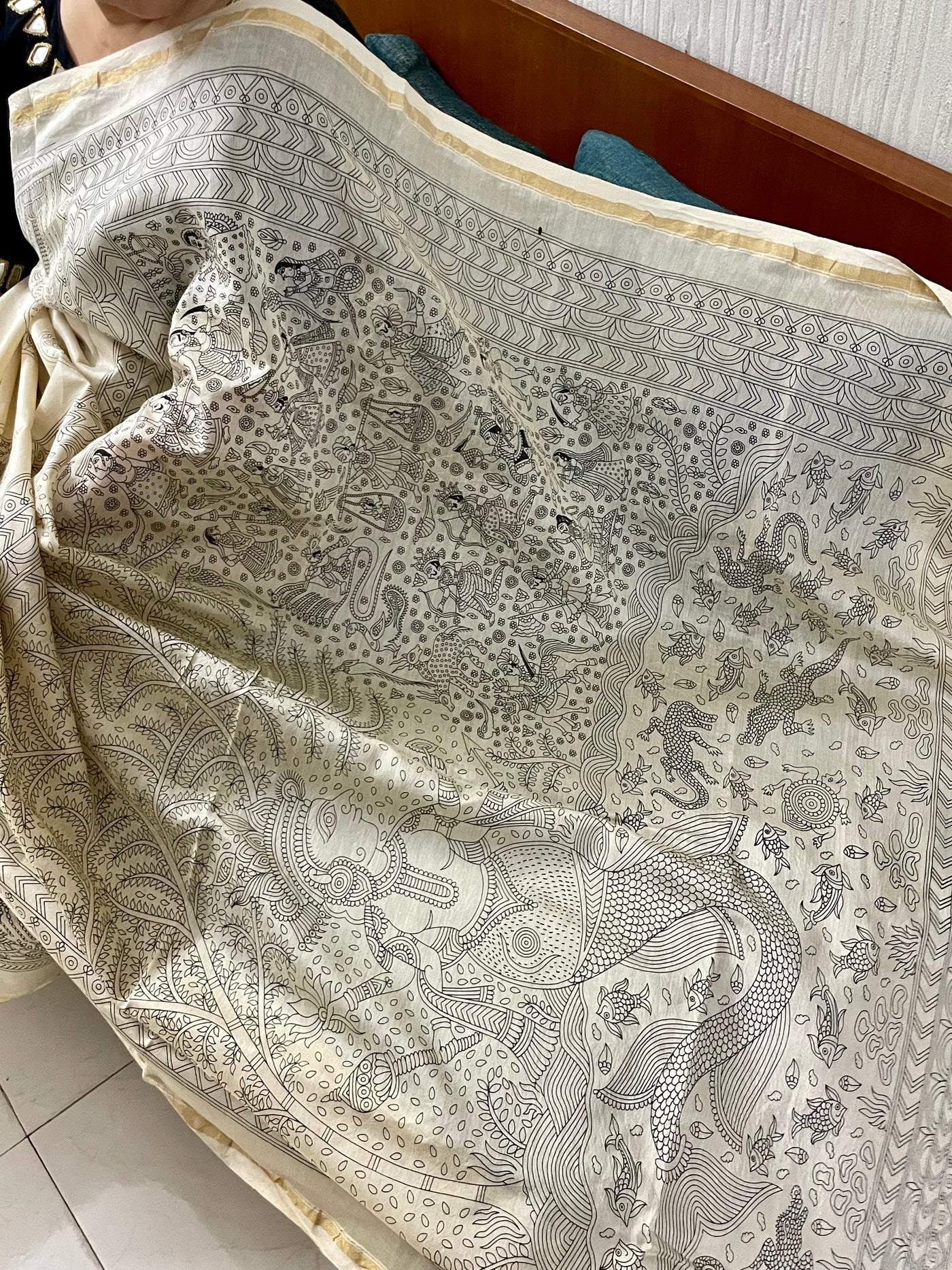 Elegant ivory white saree showcasing detailed Mata Ni Pachedi artwork created by skilled artisans