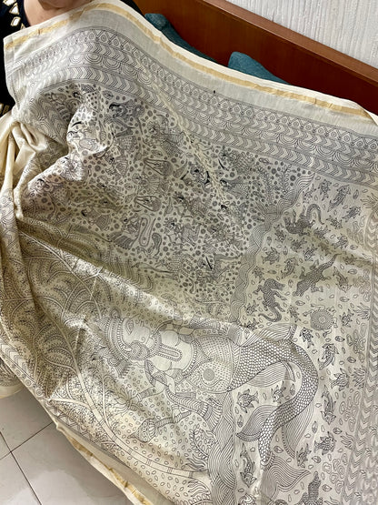 Elegant ivory white saree showcasing detailed Mata Ni Pachedi artwork created by skilled artisans