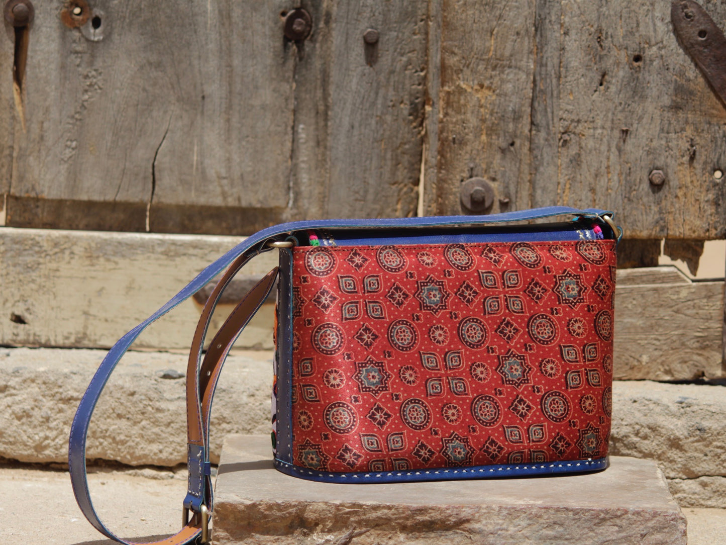 Artisan-made leather bag adorned with traditional Kutchi embroidered motifs and fine detailing