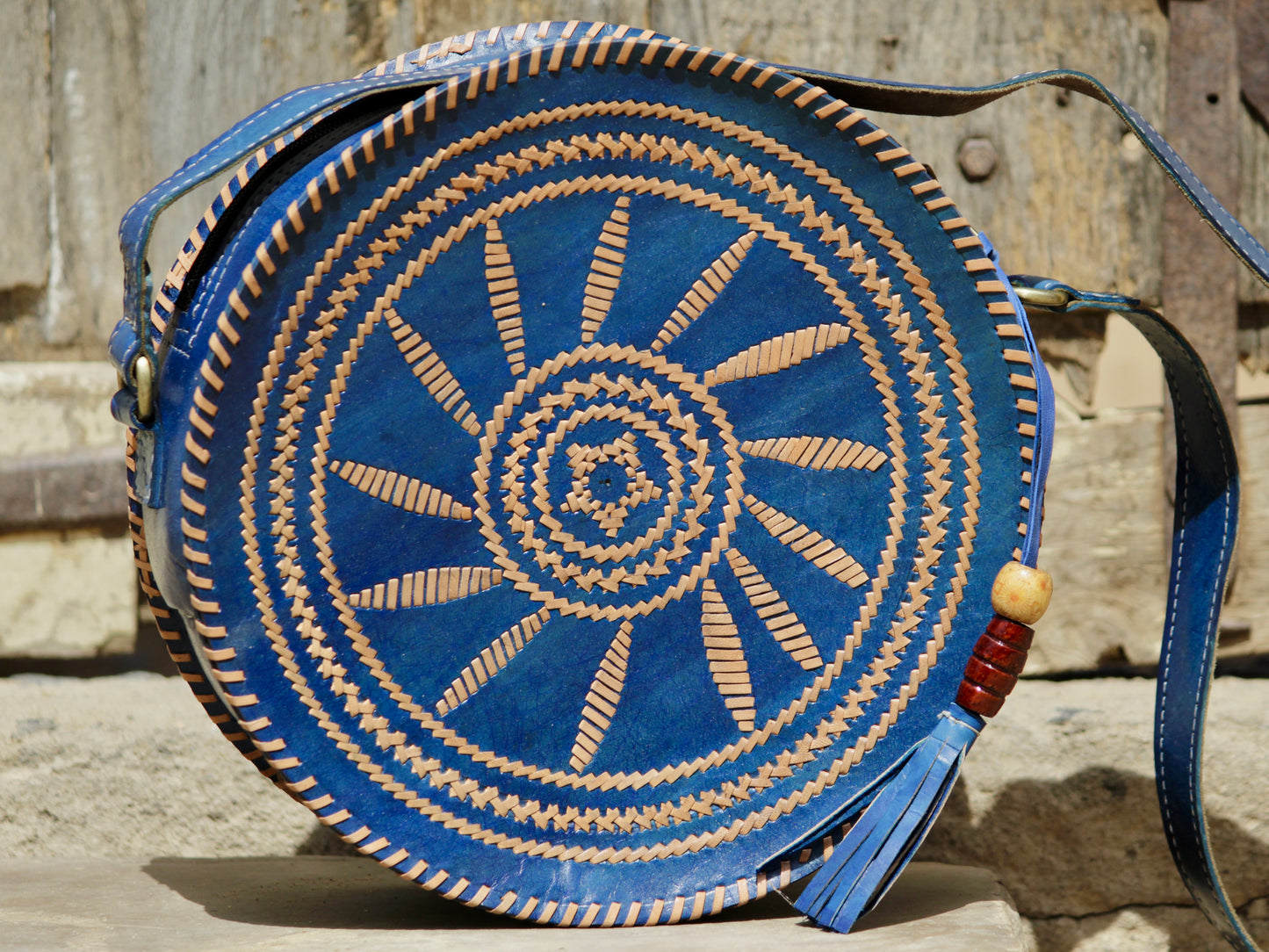 Artisan-made leather bag showcasing colorful thread embroidery and traditional craftsmanship
