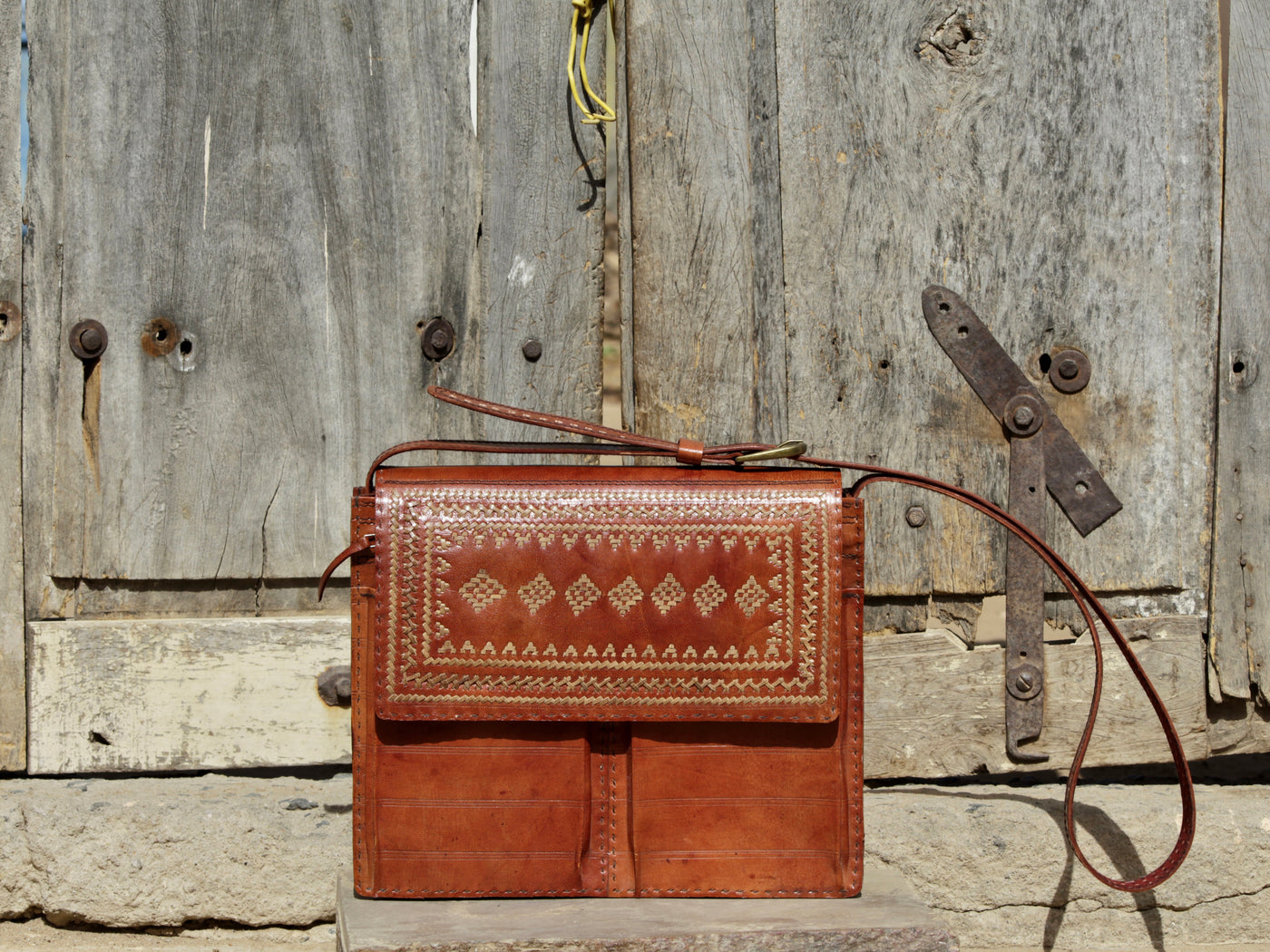 Handcrafted leather office bag showcasing decorative thread work and durable construction