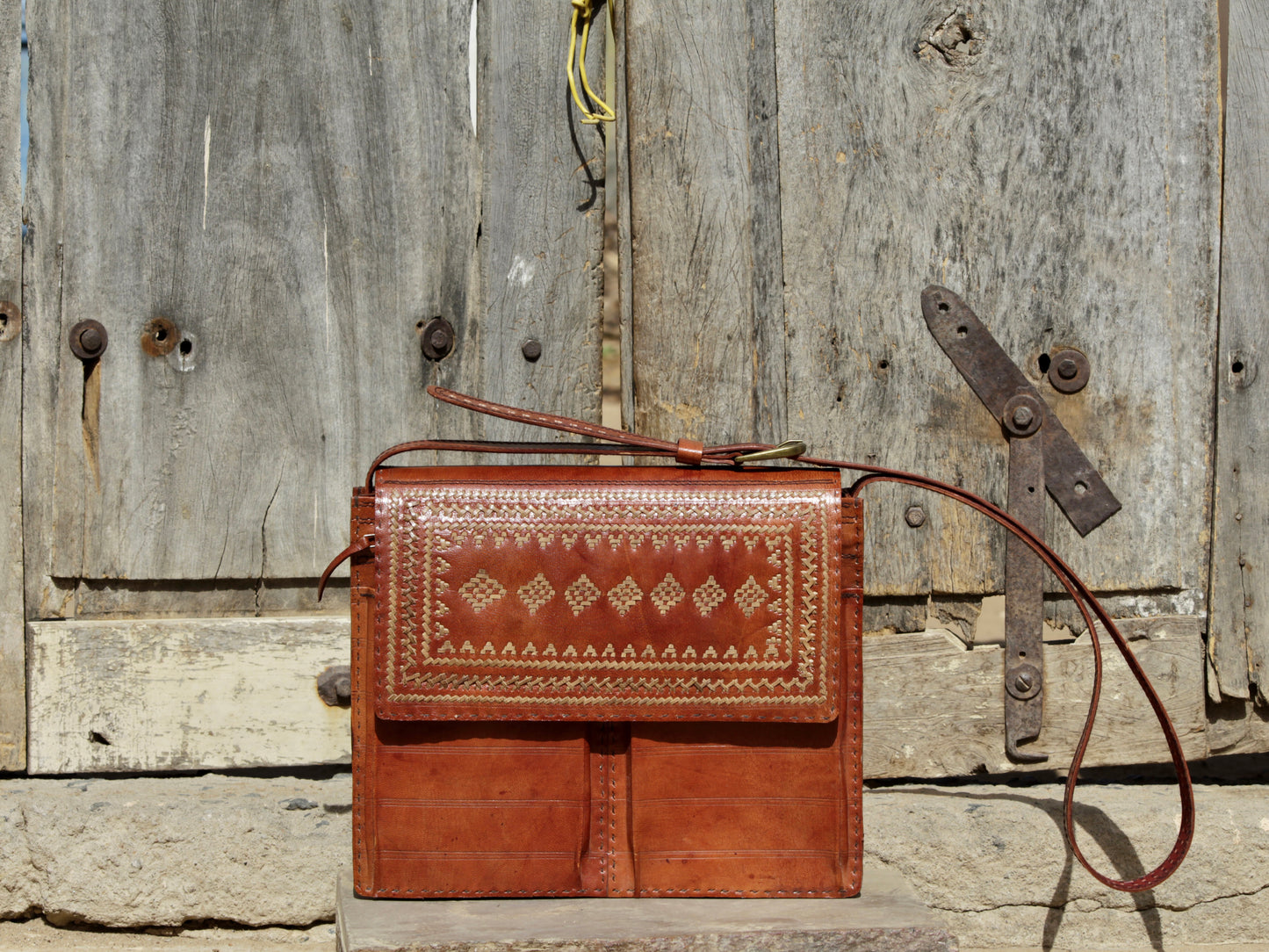 Handcrafted leather office bag showcasing decorative thread work and durable construction