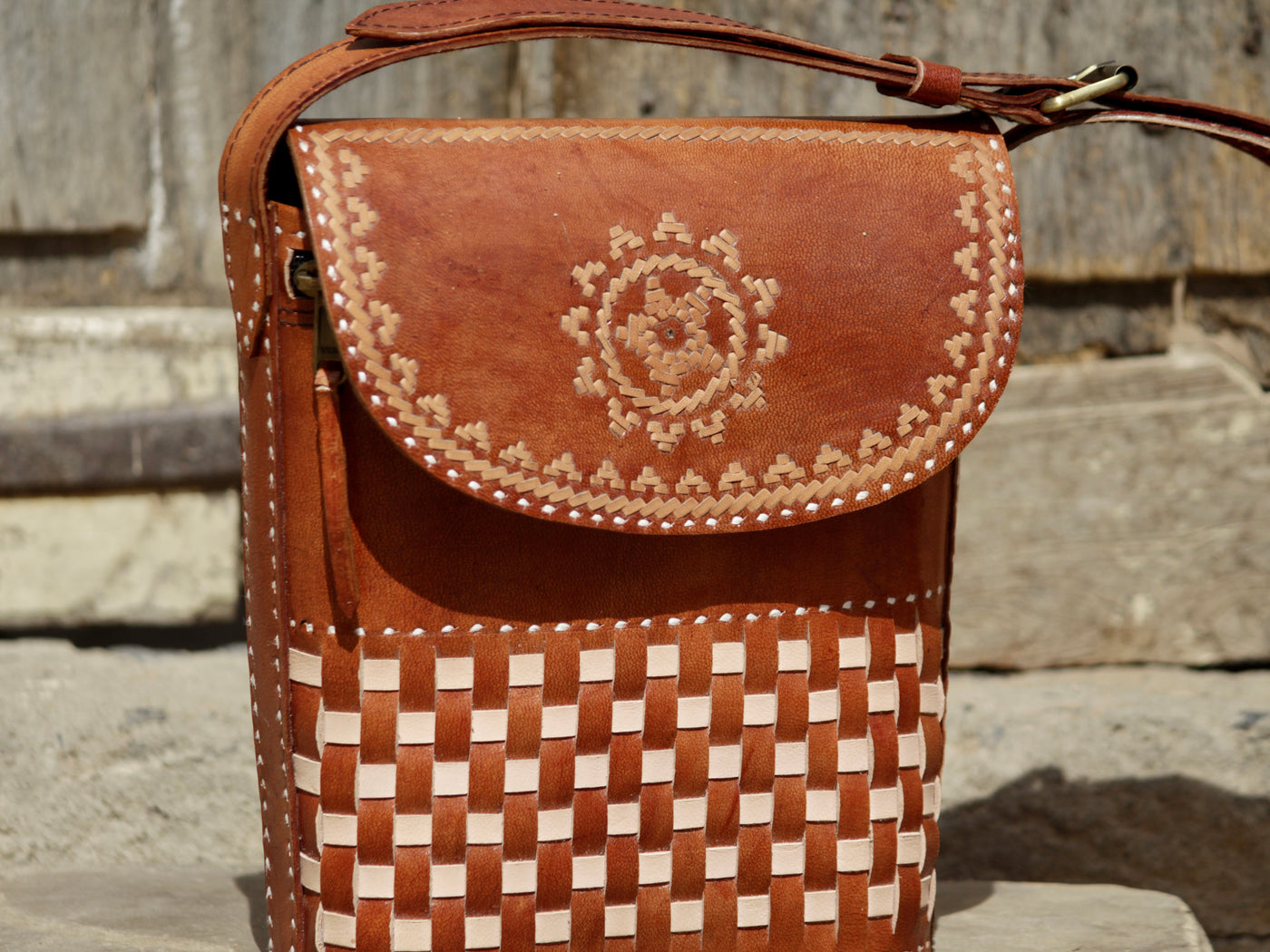 Leather sling bag featuring intricate thread work on premium handcrafted leather