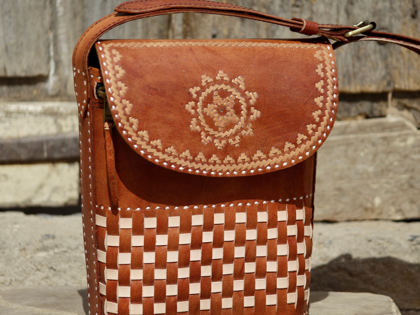 Leather sling bag featuring intricate thread work on premium handcrafted leather