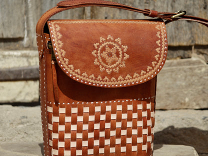 Leather sling bag featuring intricate thread work on premium handcrafted leather