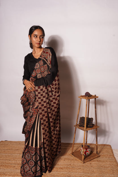Premium midnight black Ajrakh saree showcasing detailed artisan block printing on soft modal silk
