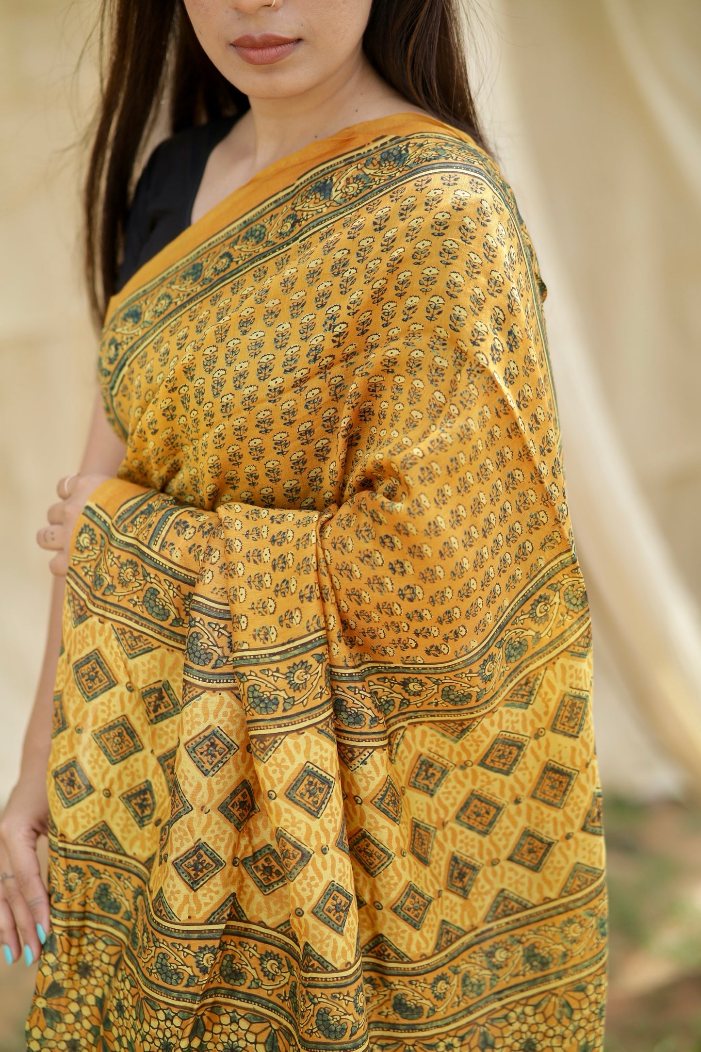 Elegant mustard yellow Ajrakh saree in Chanderi silk showcasing detailed artisan block printing