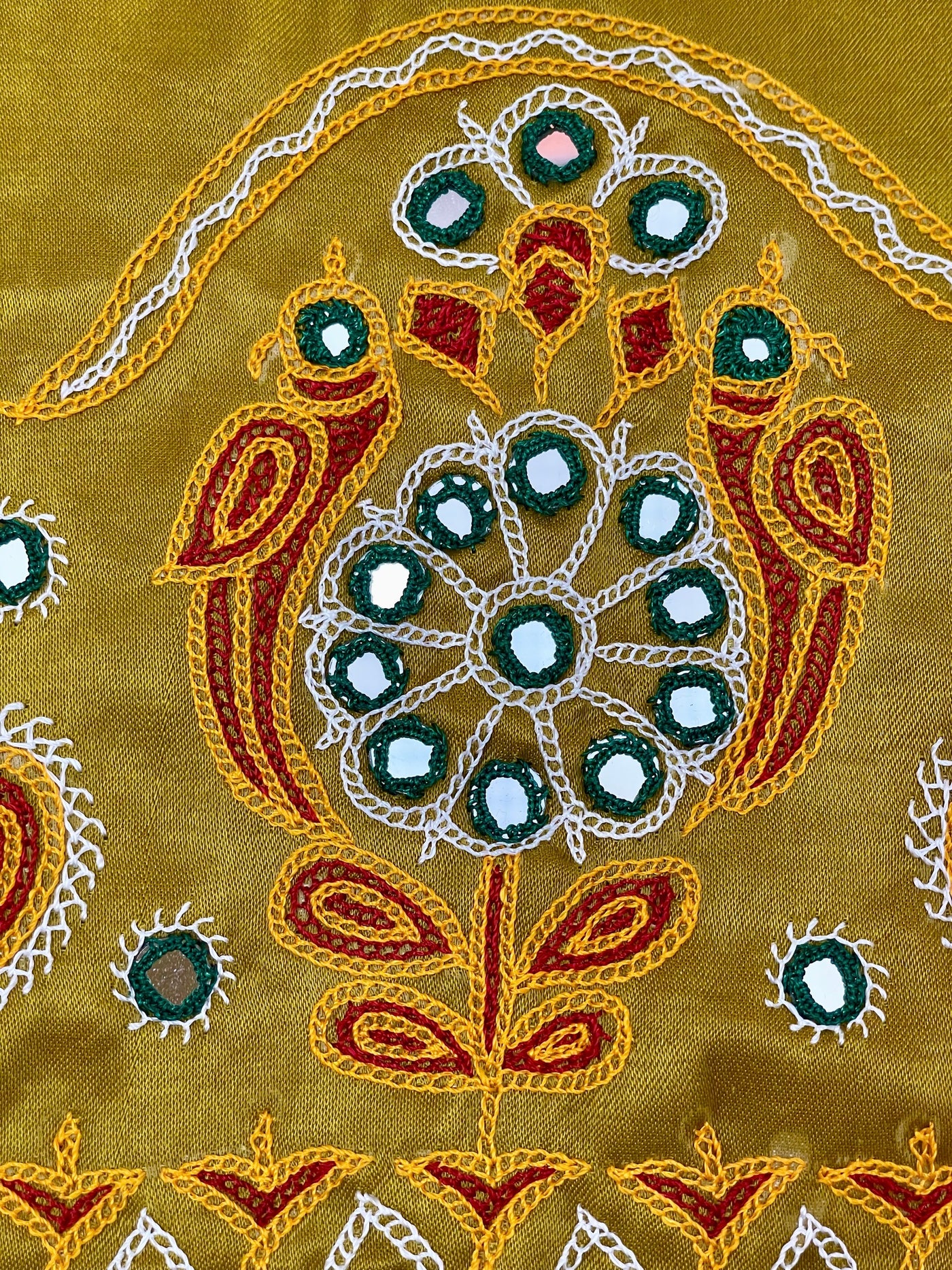 Elegant mustard yellow blouse piece adorned with beautiful Ahir embroidery motifs