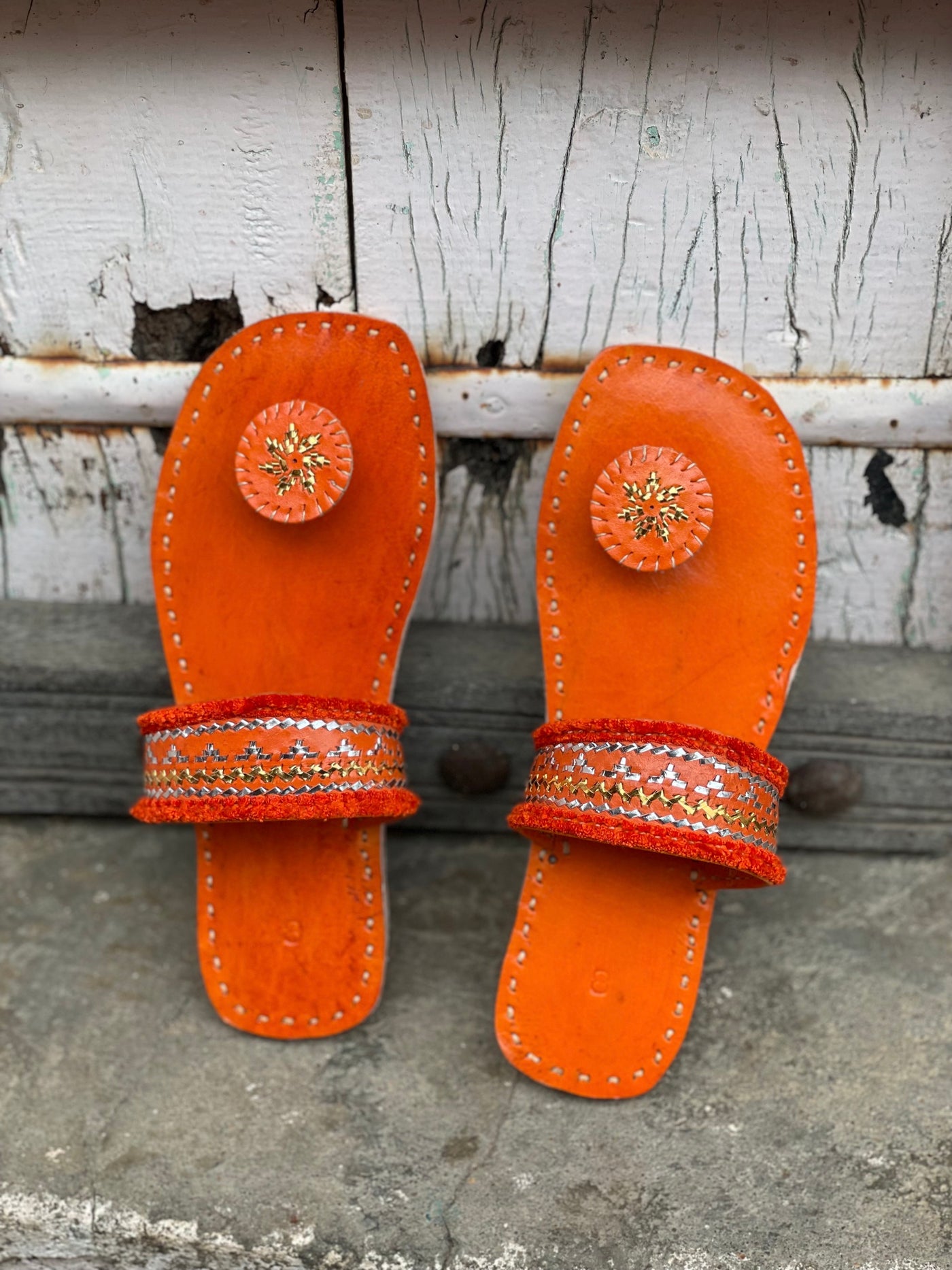 Premium orange handcrafted leather flats with fine artisan stitching details