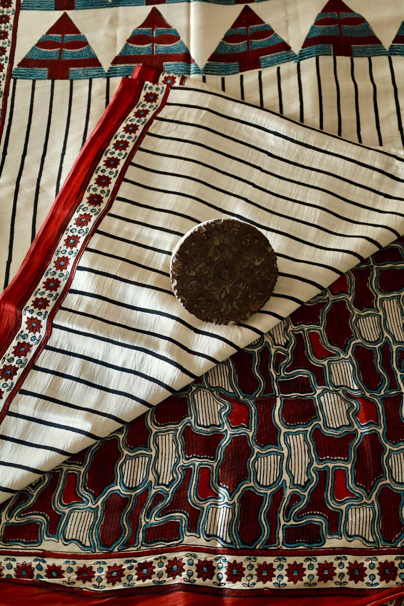 Pearl white Ajrakh modal silk saree with intricate hand block printed patterns and elegant drape