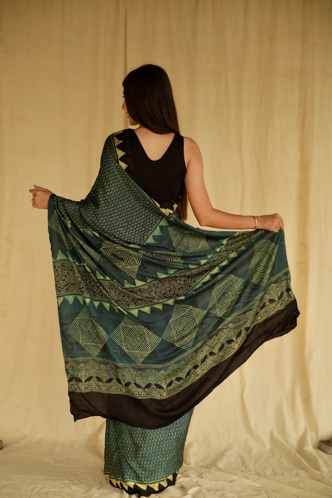 Elegant pine green Ajrakh saree crafted in luxurious modal silk with detailed geometric and floral designs