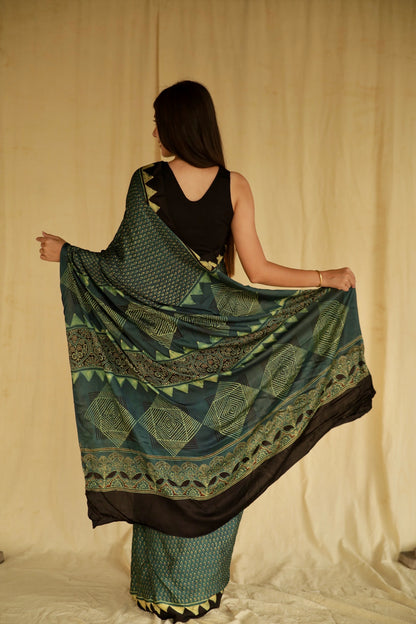 Elegant pine green Ajrakh saree crafted in luxurious modal silk with detailed geometric and floral designs