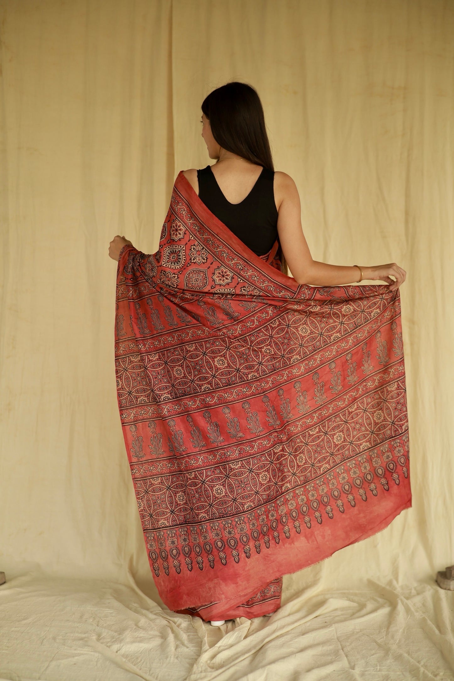 Elegant raspberry pink Ajrakh saree in Chanderi silk showcasing skilled artisan block printing techniques