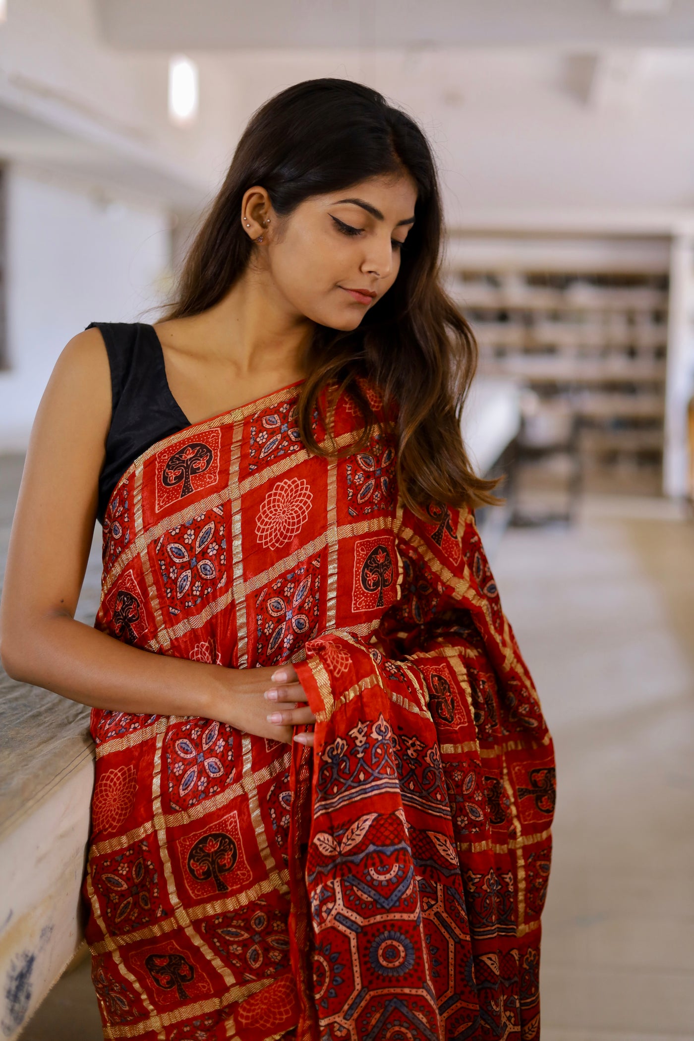 Elegant red Gharchola Ajrakh saree crafted in luxurious modal silk with traditional artisanal designs