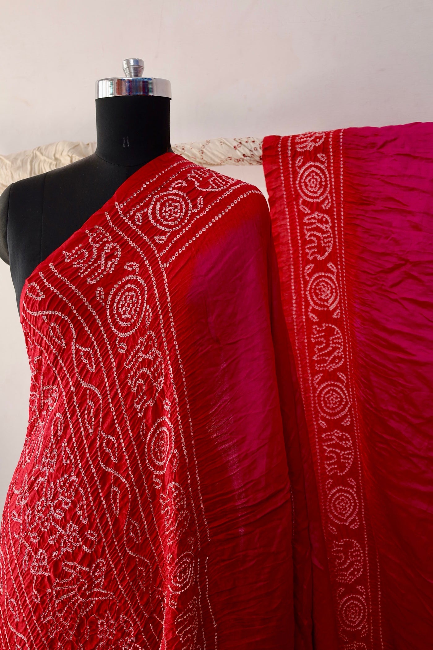 Ruby Bandhani Gajji silk saree featuring intricate tie-dye patterns and an elegant zari pallu
