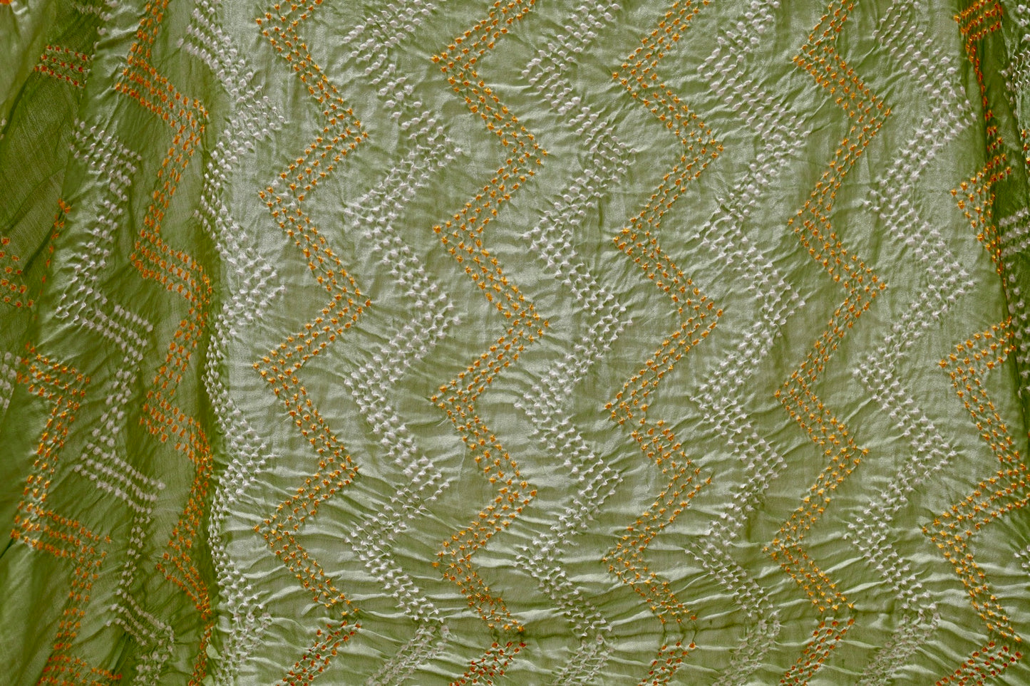 Sage green Rai Bandhani silk saree featuring intricate tie-dye patterns and an elegant zari pallu