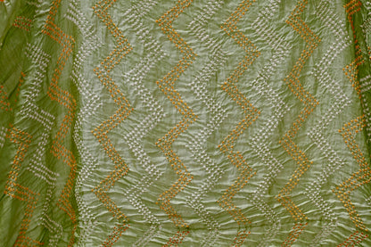 Sage green Rai Bandhani silk saree featuring intricate tie-dye patterns and an elegant zari pallu
