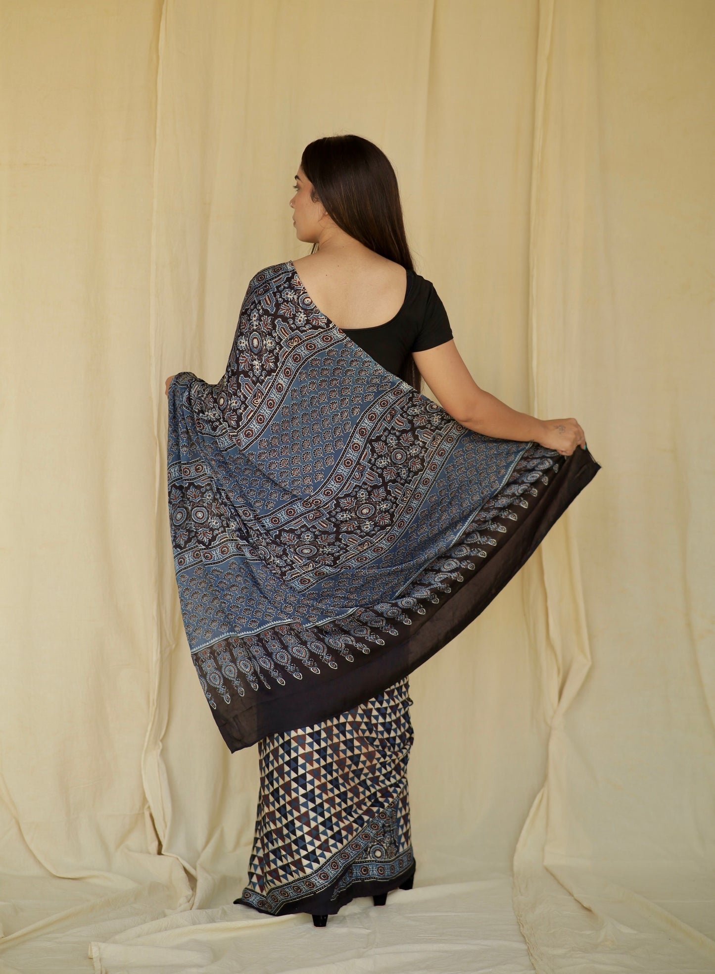 Elegant sapphire blue Ajrakh saree in modal silk showcasing skilled artisan block printing techniques