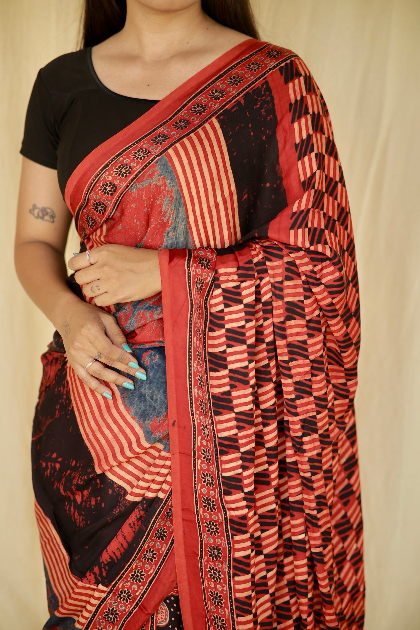 Elegant scarlet and black Ajrakh saree in modal silk showcasing skilled artisan block printing techniques